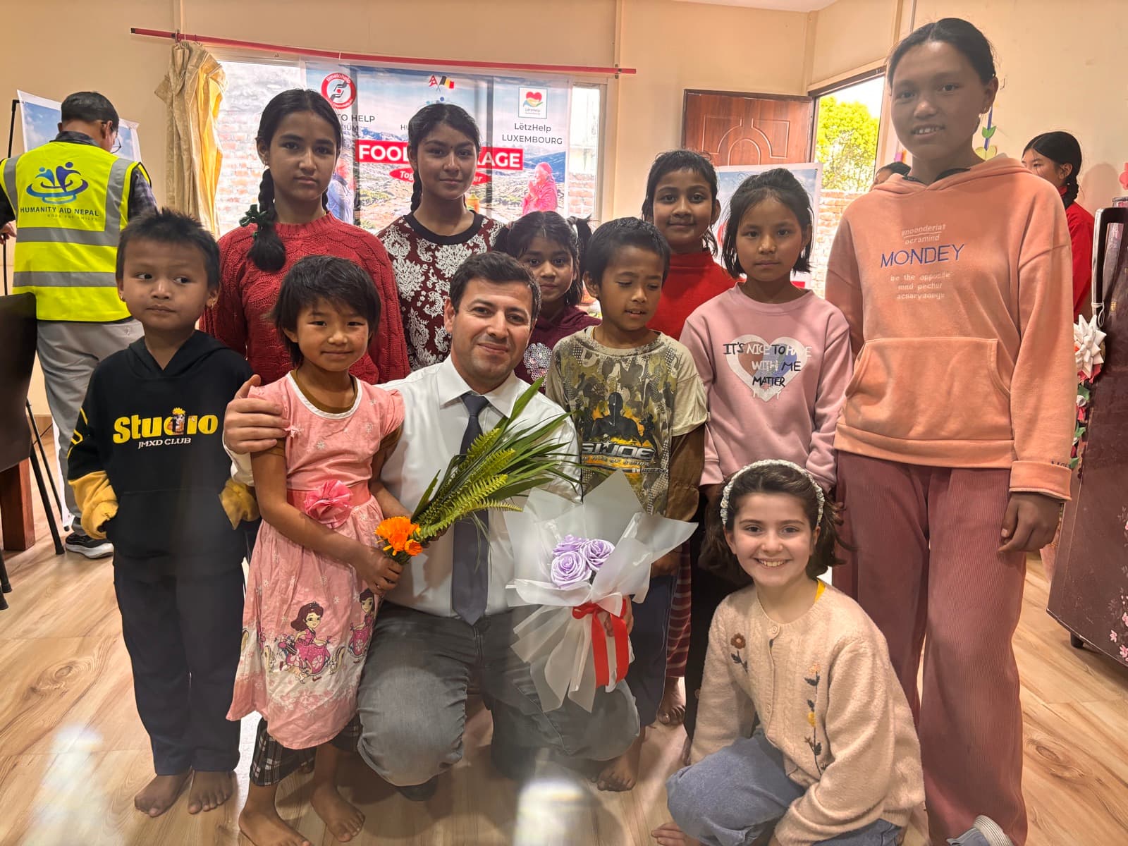 Children and volunteers in a clothing shop after choosing new clothes