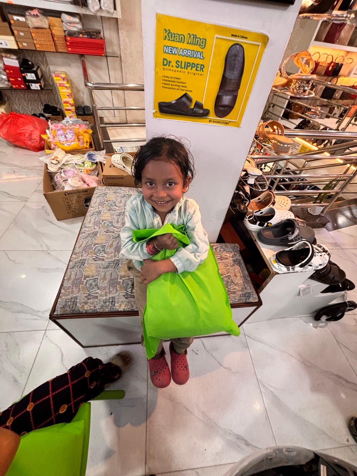 A girl with a bag of new shoes in a shoe shop
